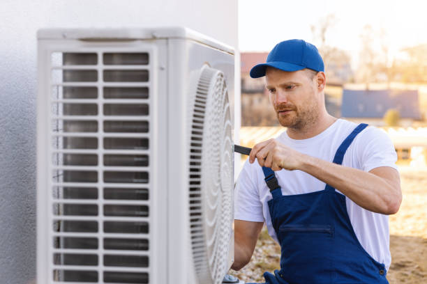 HVAC technician servicing an outdoor air conditioner in Visalia